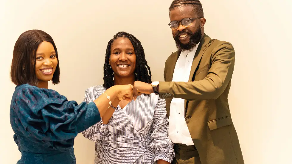 partners community Young adult shaking hands with a community employer or mentor in a professional office setting, natural light and supportive atmosphere.