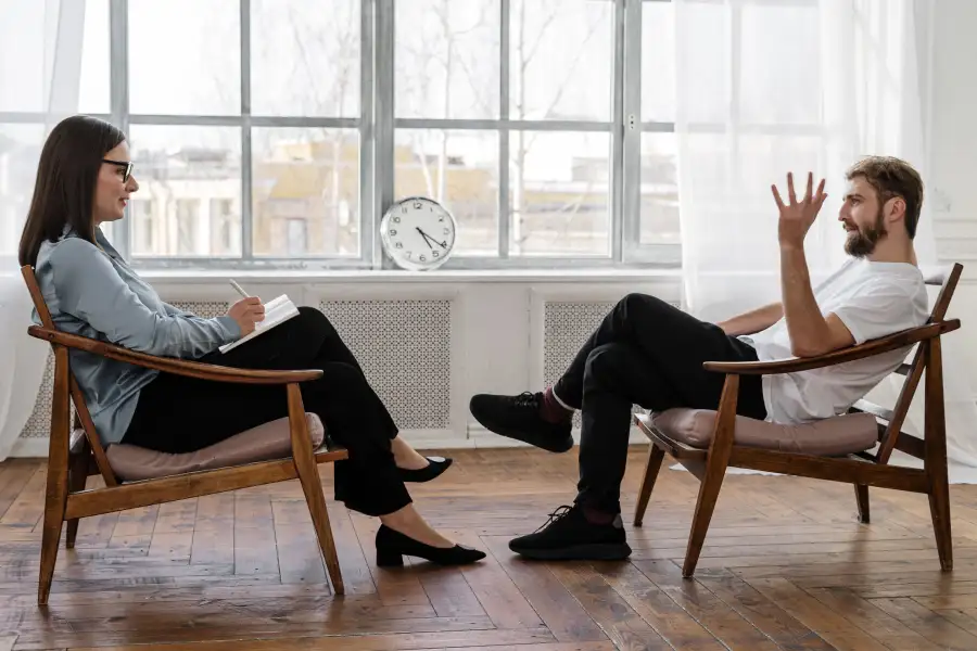 Therapist helping a young adult build independence skills